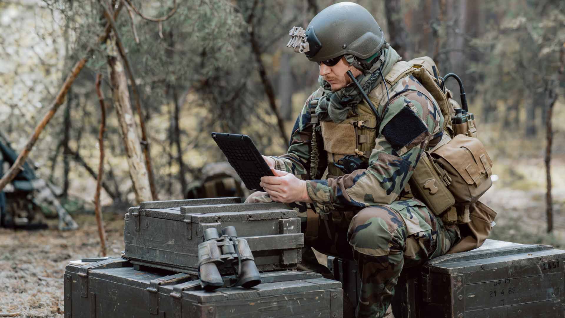 Soldier checking 5G network device security on the field